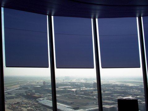 Glare protection with transparent film roller blinds at airport tower London Heathrow