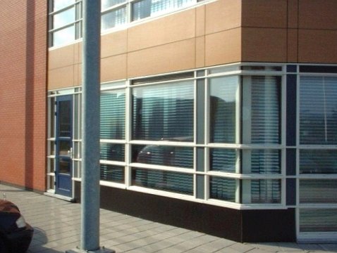 Vertical louver blind with pleated film slats